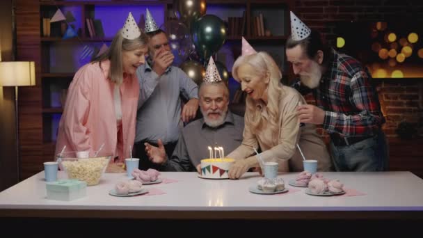 Birthday Party Surprised Senior Man Party Hat Sitting Dinner Table — стоковое видео