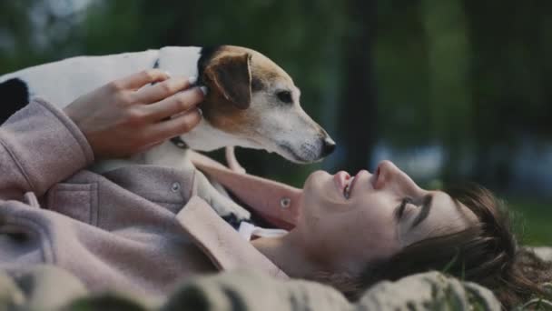 Pretty Young Woman Lying Blanket Park Holding Jack Russell Dog — Stock Video