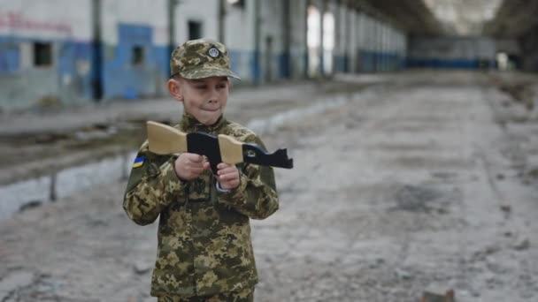 Little Soldier Boy Holding Toy Assault Rifle Taking Riim Standing — Stockvideo