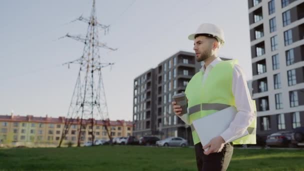 Serious Engineer Protective Helmet Walking Laptop Power Line Holding Coffee — Stock Video