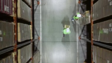 Lojistik Deposu. Üst Manzara. Forklift operatörü karton kutulu paleti kaldırıyor. Ürünleri Küresel Sevkiyata Hazır Dağıtım Merkezi, Müşteri Teslimatı