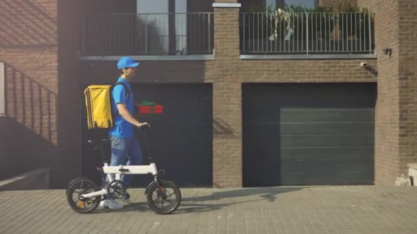 Beyaz Bisikletli Kurye Hediye Kutusu Mavi Üniforma Sarı Sırt Çantası — Stok video