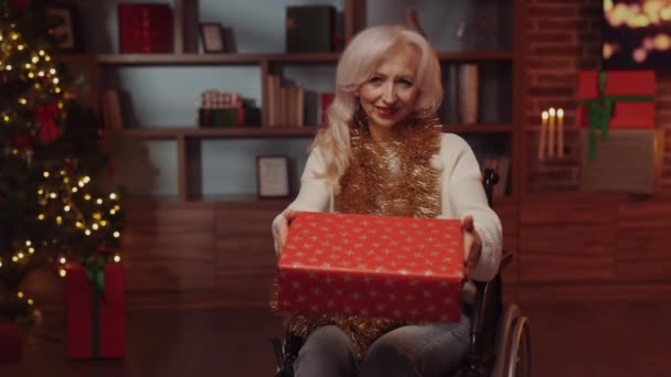 Elderly Disabled Lady Wheelchair Holding Gift Box Wrapped Red Paper — Stock Video