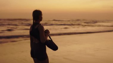Sportif Kız Sahilde Dışarı Çıkıyor, Hayal Kuruyor ve Düşünüyor. Eğitimden sonra Sunset Walking on the Seashore 'daki çekici koşucu kadın. Spor ve İnsanlar Konsepti