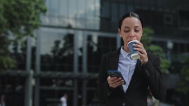 Kahve molasında Smartphone 'u kullanarak Yalnız Ofis İşçisi. Patroniçe, işten sonra dışarıda kahve içiyor ve cep telefonunda mesajlaşıyor. Halk ve Teknoloji Konsepti