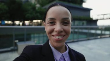 Bakış açısı. Genç Çekici İş Sözcüsü Meslektaşları Arıyor, Akıllı Telefon Kamerasına el sallıyor. Video konferansında gülümseyen sevimli bayan insanları selamlıyor. Halk ve Teknoloji Konsepti