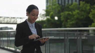 Bağlı Saçlı Genç Kadın İşe Gidiyor ve Çalışma Planlarını Yazıyor. Başarılı Yetişkin Girişimci Konferansa Yürüyor ve Dijital Tablet Kullanıyor. Halk ve Teknoloji Konsepti
