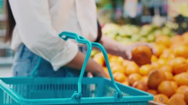 Canlı Bakkalda Taze Portakal Alışverişi yapan Kadın. Süpermarket. Taze sebze ve meyve reyonu. Kapat.