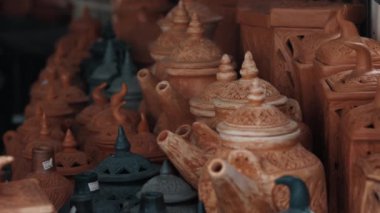 Asya sokak pazarında Asya çay seremonisi için çeşitli terracotta ve siyah seramik kaplar. Süslü yüzeyi ve güneş yanıklarının doğal işaretleriyle satılık geleneksel eşyalar.