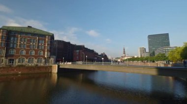 HAMBURG, Almanya - 23 Eylül 2024: Eski şehrin kentsel bölgelerini birbirine bağlayan nehrin yukarısındaki köprü ve ulaşım üstgeçidi. Şehrin tarihi blokları arasındaki su kanalının üzerindeki viyadikler.