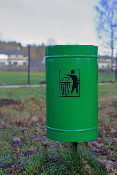 Green garbage can on a blurred background in Koszalin, Poland