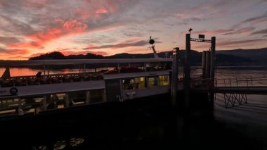 sunset over the port with departing boat