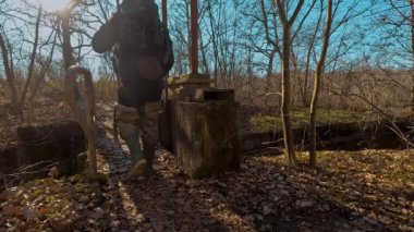 man trekking over a bridge