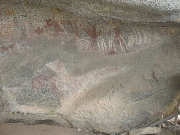 Indigenous Arawak tribal pictographs on a cave wall in Aruba