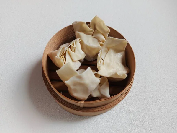 Raw dumpling or dimsum on bamboo steamer. It is traditional food from china. Savory taste.