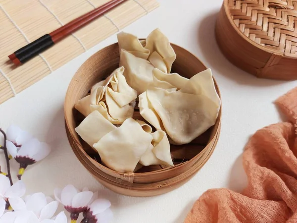 Raw dumpling or dimsum on bamboo steamer. It is traditional food from china. Savory taste.
