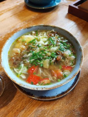 Soto ayam. It is traditional food from indonesia. Concist of chicken,tomato, celery,spring onion and spices souo.