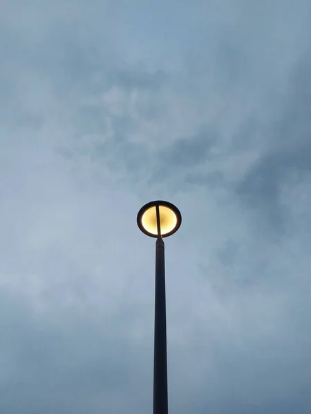 street lighting pole against the cloudy sky. Negative space photography concept