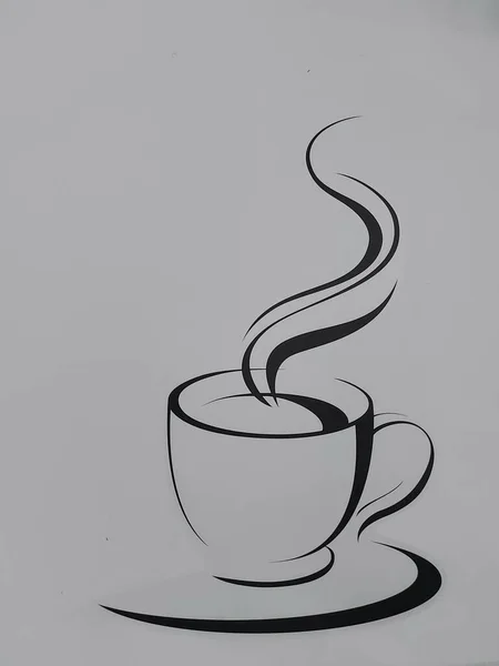 Coffee cup line drawing image on the white wall.