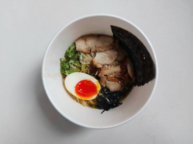 Chicken ramen noodle. It is authentic food from japan. Usually consist of noodle, soup, boiled egg, spring onion, seaweed, chicken meat. Completed with chopsticks. Savory taste