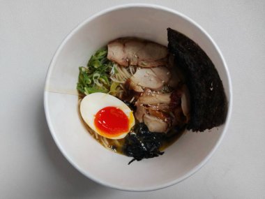Chicken ramen noodle. It is authentic food from japan. Usually consist of noodle, soup, boiled egg, spring onion, seaweed, chicken meat. Completed with chopsticks. Savory taste