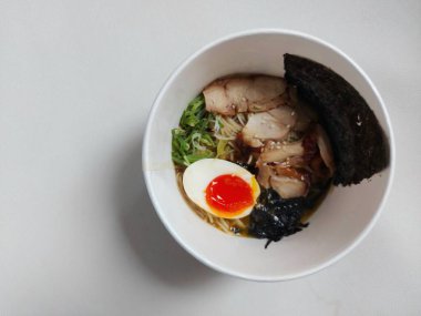 Chicken ramen noodle. It is authentic food from japan. Usually consist of noodle, soup, boiled egg, spring onion, seaweed, chicken meat. Completed with chopsticks. Savory taste