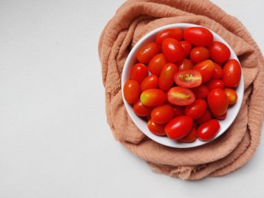 Cherry tomatoes on white bowl. Healthy food and fresh. Isolated background in white