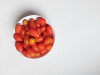 Cherry tomatoes on white bowl. Healthy food and fresh. Isolated background in white