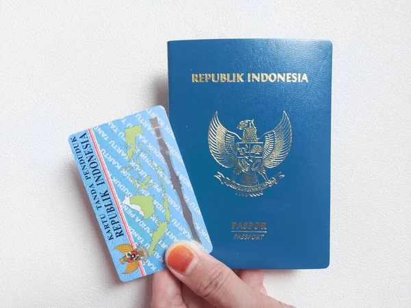 Indonesian passport and indonesian identity card. With indonesian text \'Republik indonesia\' and \'kartu tanda penduduk\'. It means Indonesia Republic and \'identity card\'. Isolated background in white