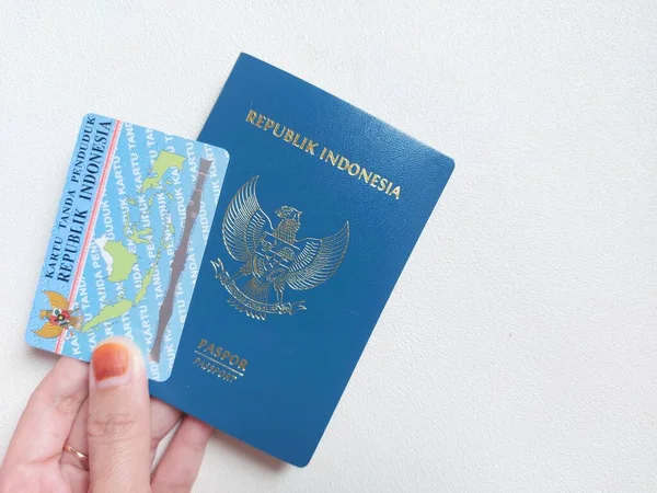 Indonesian passport and indonesian identity card. With indonesian text \'Republik indonesia\' and \'kartu tanda penduduk\'. It means Indonesia Republic and \'identity card\'. Isolated background in white