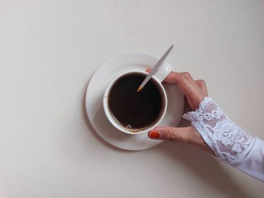 Black coffee on white porcelain cup. Isolated background in white