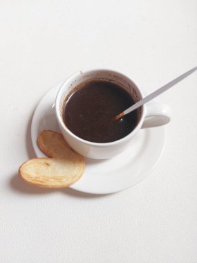 Black coffee on white porcelain cup. Isolated background in white