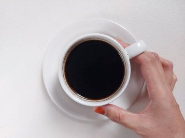 A cup of black coffee on white porcelain cup. Coffee time photography concept. Isolated background in white