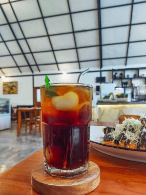 Lychee tea with ice and mint leaf on transparent glass. Refreshing drink. 