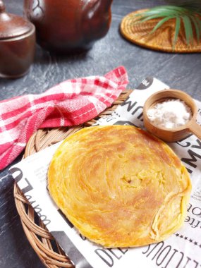 Roti canai or Roti Maryam.  it isa type of flatbread with Indian influence that can be found in several countries in Southeast Asia, including Brunei, Indonesia, Malaysia and Singapore.
