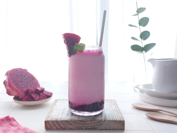 korean dragon fruit milk on transparent glass. consist of dragon fruit jam and milk