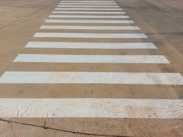 zebra crossing on concrete road.  facilities for crossing for pedestrians