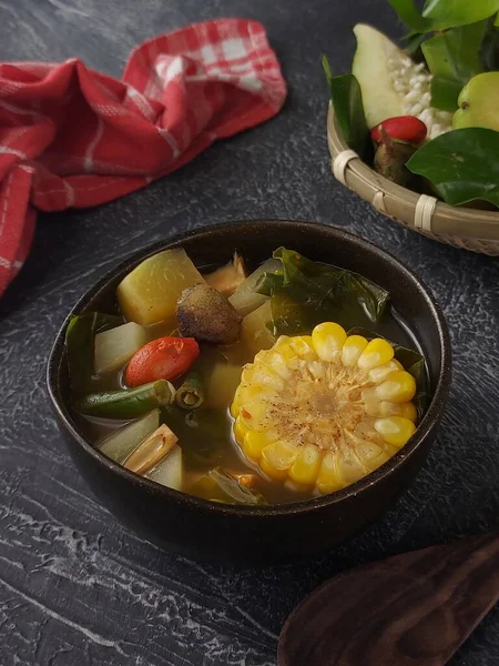 stock image Sayur asem. It is traditional food from indonesia. Made from much vegetable such as young papaya, gnetum gnemon leaves and fruit, chayote, long beans, young jackfruit, tamarind fruit with sour soup