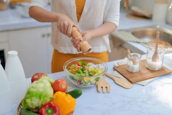 stock image Closeup mid section of a chef putting salt and Pepper in the kitchen