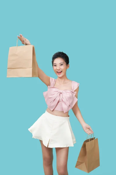 Cheerful Beautiful Asian Woman Holding Craft Shopping Bags Light Cyan — Stock Photo, Image