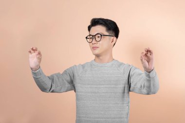 Front view of a asian man with his hands palms in front of him