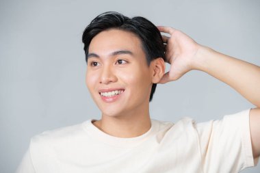 Handsome happy man smiling confident touching hair with hand up gesture,