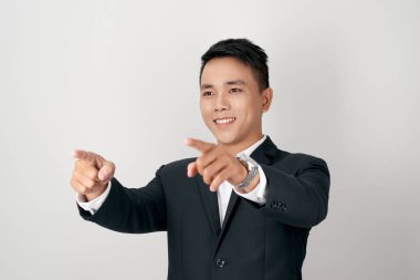 You are the one I need! Good-looking young man pointing  and smiling while standing against white background