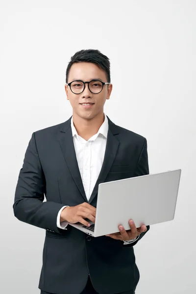 Smiling Young Man Standing Suit Glasses Holding Open Laptop — Zdjęcie stockowe