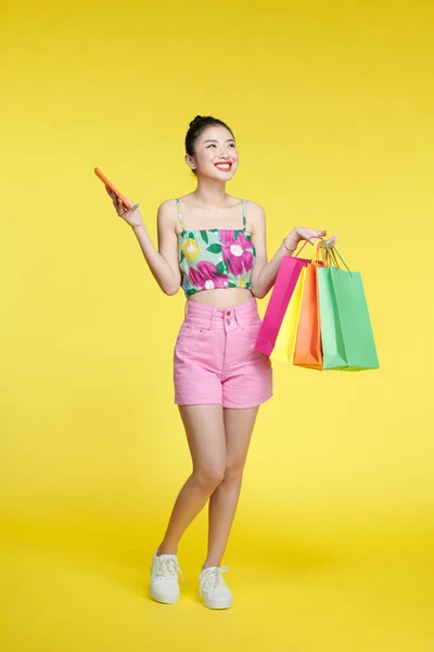 Asian Woman Holding Shopping Bags Smartphone Face Happily — 图库照片