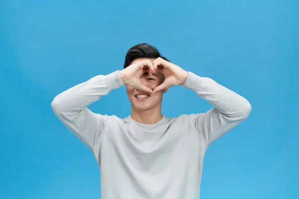 Handsome Man Showing Heart Cover Eye Isolated Blue Color Background — Stock Photo, Image