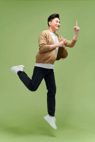 Energetic Excited Young Asian Man Jumping Pointing Hand Empty Space — Stock Photo, Image