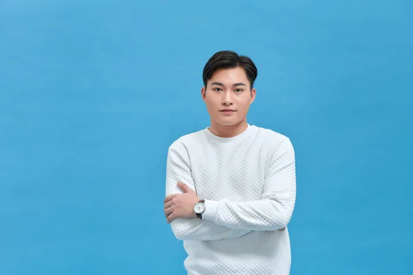 stock image Studio shot of young handsome man against blue background