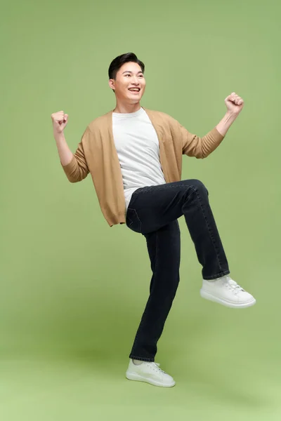 Full Length Satisfied Young Man Celebrating Success Isolated Green Background — Stock Photo, Image