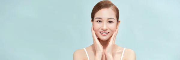 A smiling woman clean fresh face isolated on pastel background, banner